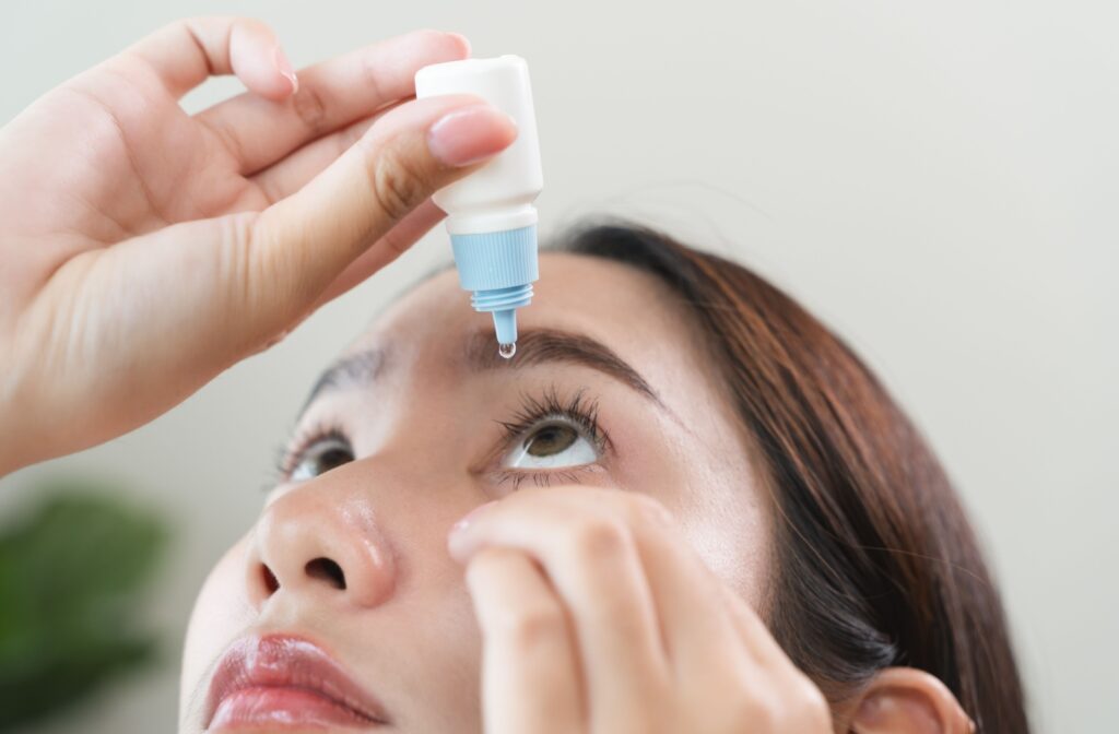 A person using artificial tears to help relieve dry eye symptoms.