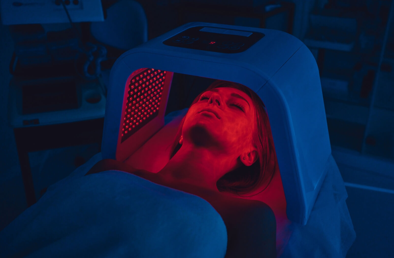 A person undergoes red light therapy at a doctor's office.