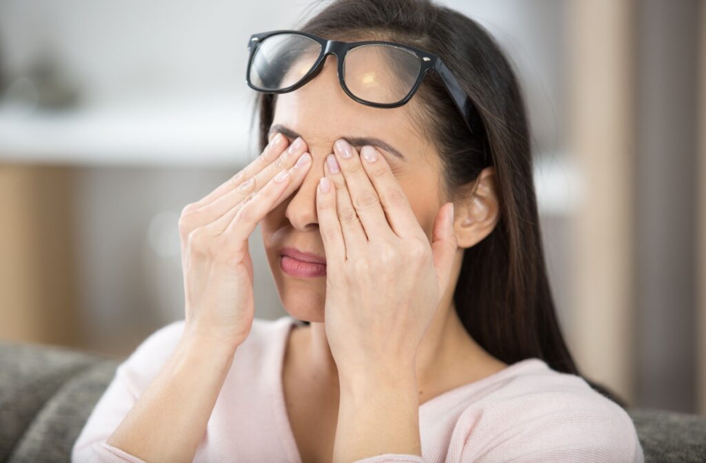 Person rubbing their eyes due to seeing flashes of light.